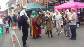 Dinosaur nearly knocks girl down in the highstreet!