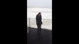 Storm Hercules batters Porthleven Cornwall - Girl almost falls over in wind!