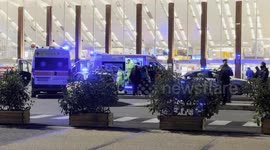 Two ambulances with flashing lights on in Piazza dei Cinquecento, in front of Termini Station in the evening in Rome.