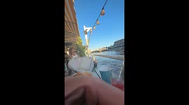 2 black swans are fighting in front of Afloat bar on the Yarra River, Melbourne and then a man tried to break them up