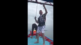 Squid squirts ink in tourist's face on sea fishing trip
