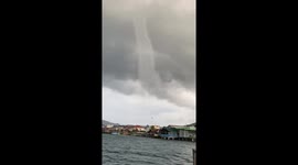 Towering waterspout tornado damages coastal homes
