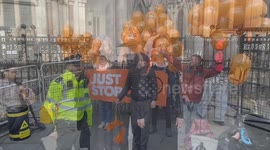 Smoke and popping balloons in support of jailed climate activists outside the Royal Courts of Justice in London