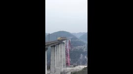 Workers brave 320m heights to inspect railway bridge in SW China