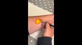 Forearm turns into a canvas as artist creates an eye-catching dinosaur design with face paints