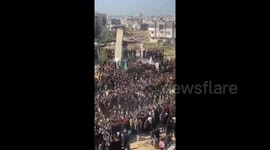 A large number of Palestinians gather with resistance fighters around the home of the late Hamas leader Yahya Sinwar in Khan Younis