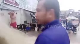 Locals smash wall to ease flash flood in the Philippines