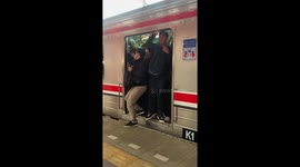 Crushed commuters cram into train carriage in Indonesia