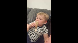 Sleepy toddler can't wait to eat ice cream despite being half asleep