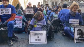 A large group of protesters has blocked roads outside the Royal Courts of Justice in solidarity with climate activists who are jailed