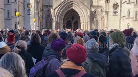 The Climate Choir Movement stands alongside protesters outside the Royal Courts of Justice in London