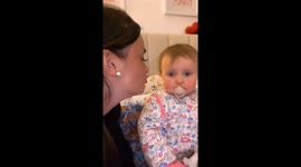 Toddler rolls eyes at mom for kiss attempt
