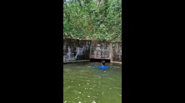 Swimmers navigate water tunnel in Puerto La Cruz, Venezuela