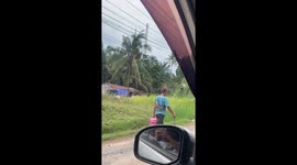 Person carries fish across back in Jambi video