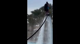 Man lifts and spins with old woman on flyboard in Egypt
