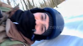 Man snowboards lying down on Monte Nerone in Marche, Italy