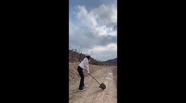 Woman hits golf ball with shovel in Liaoning, China