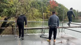 Man falls into pond while walking on a board in Zhejiang, China
