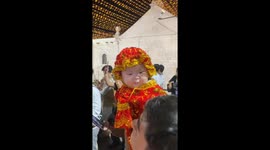 Baby dressed as Santo Niño dances in Cebu City mass