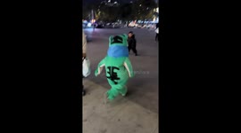 Child runs crying after being chased by another in frog costume