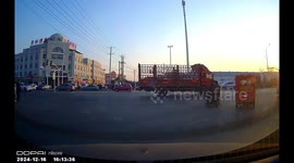 Dashcam captures truck shoving car through intersection in Shandong, China