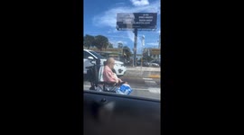Elderly woman rides mobility scooter in Tampa traffic