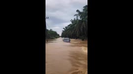 Drivers battle through torrents to escape severe floods in Indonesia