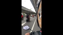 Chill mother lies face-down on top of motorcycle-pulled cart