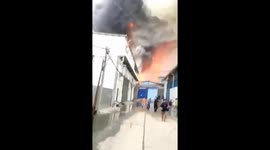 Workers flee as raging fire rips through warehouses near airport in Indonesia
