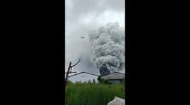 Planes fly through clouds of smoke rising from fire near airport in Indonesia