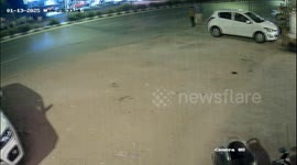 Speeding car smashes into parked vehicle narrowly missing two standing nearby