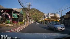 Youngster quickly turns back when he runs in front of car to collect ball