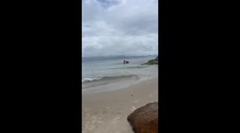 Street vendor dressed as Spiderman sells goods in the sea in Santa Catarina, Brazil
