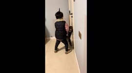 Cat and child playfully fight in Henan, China