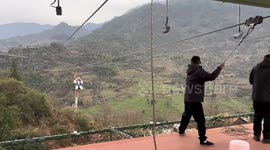 Man gets stuck on zipline during mountain climb in Zhejiang, China