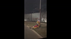 Woman helps mascot and child on roadside in Tangerang, Indonesia