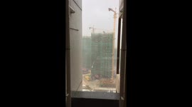 Crane falls at construction site in Hubei Province due to strong winds
