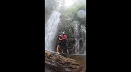Person falls near Cataratas El Tigre waterfalls in Costa Rica