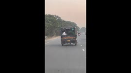 Person and dog share a moment in auto-rickshaw in Cuttack, Odisha