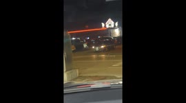 Person reverses from parking lot near police car in Dubuque, Iowa