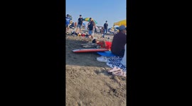 Dog and owner nap on the beach in Barranca, New Mexico, USA