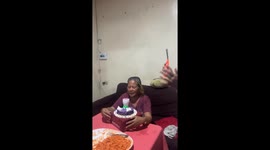 Grandmother surprised by lotus flower candle in Balasan, Philippines