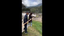 Woman and staff cross river on tightrope in Jiangxi, China