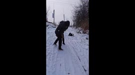 Man playfully pushes wife down snowy slope in Xinjiang, China