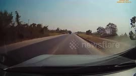 Passenger sitting on pickup truck falls from the back onto road