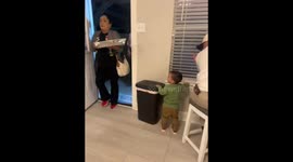 Boy offers a drink to his grandpa in Texas, USA