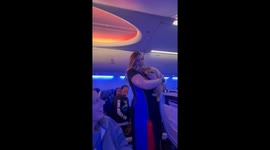 Flight attendant delights passengers by lifting up adorable puppy ahead of takeoff