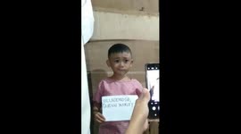 The boy frowns funny while taking a photo!