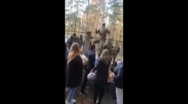 Relatives and friends of the mobilized give them things, food and hot tea through the fence