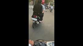 The girl does not know what to do with melting ice cream while riding a bike!